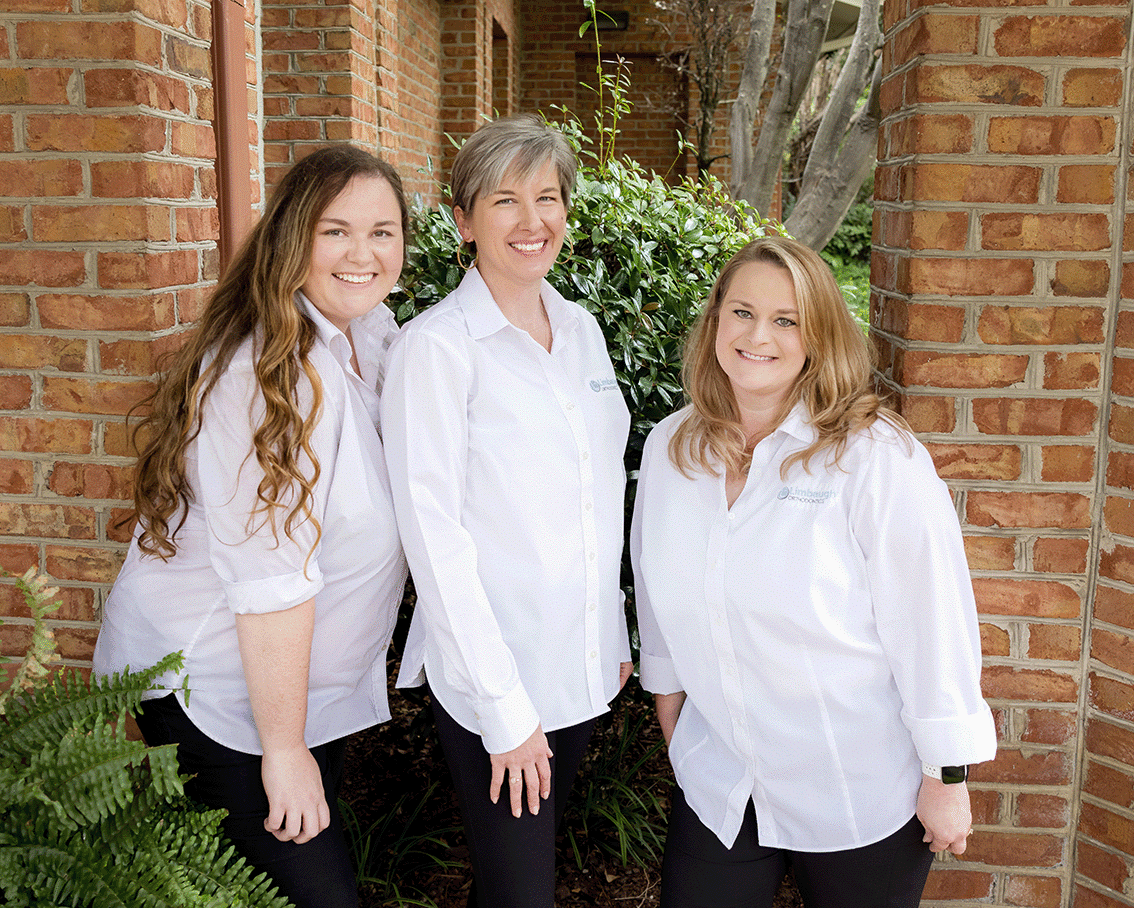 Three Limbaugh Orthodontics team members outside the office