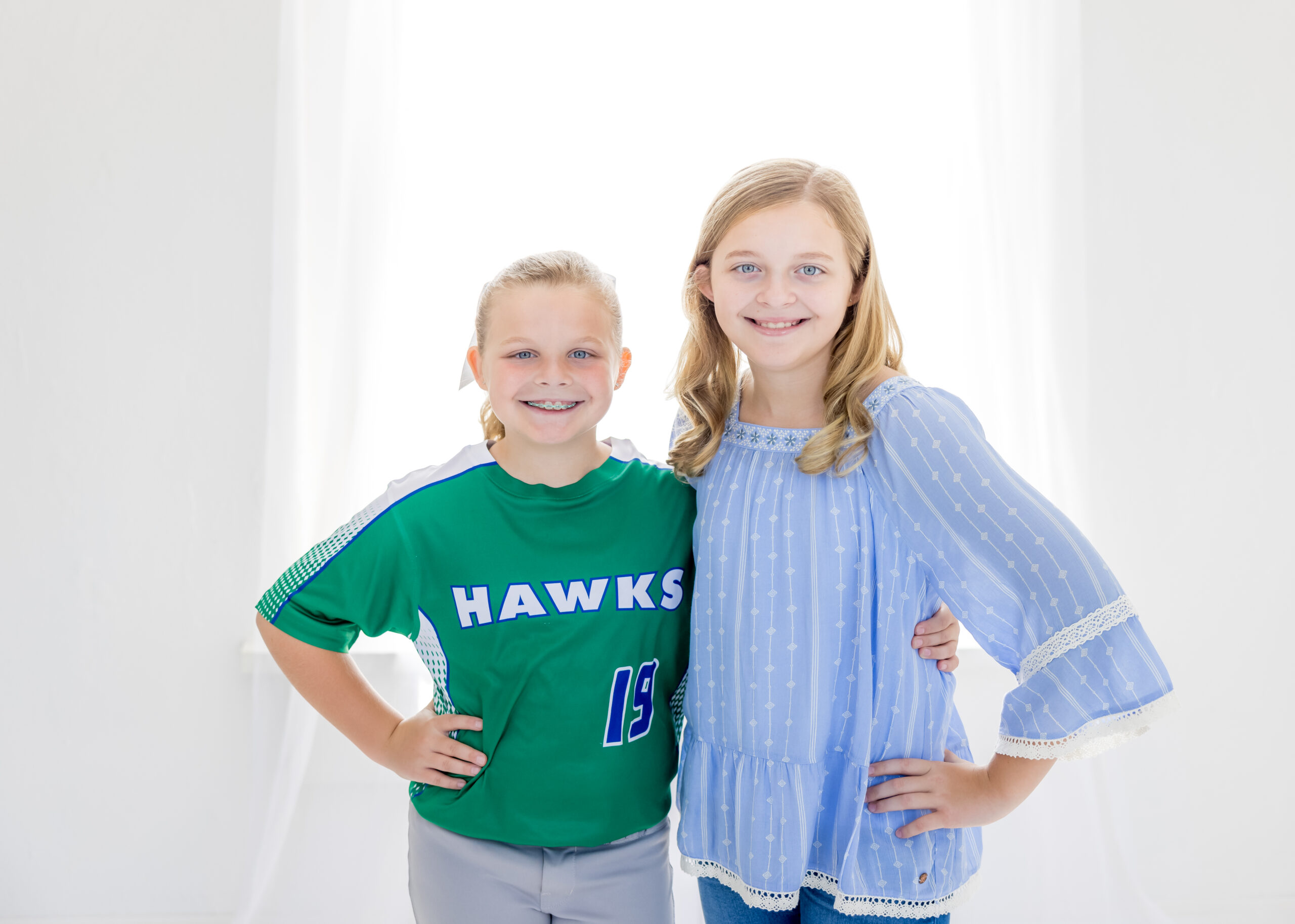 Two young Limbaugh Orthodontics patients smiling together