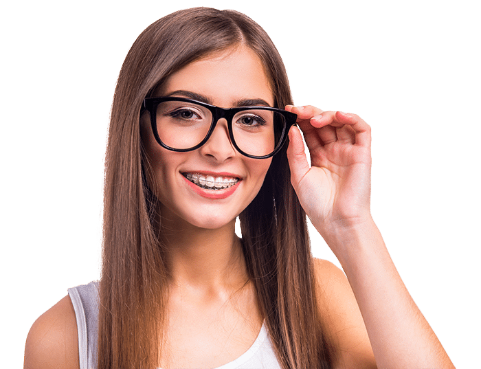 Teen with ceramic braces smiling and adjusting her glasses
