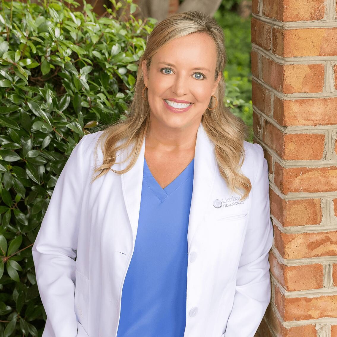 Dr. Lindsay Limbaugh in her white coat outside the Huntsville office